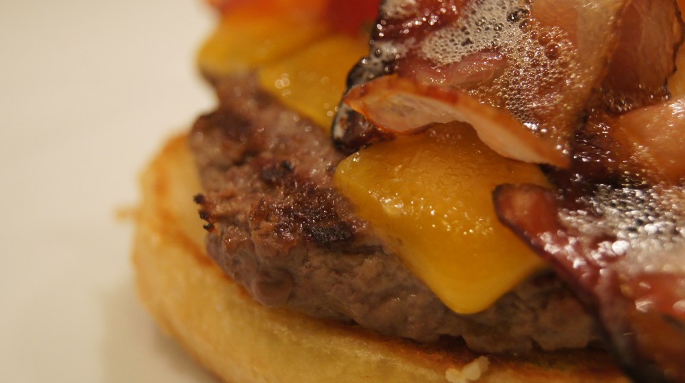 Macro image of a bacon cheeseburger