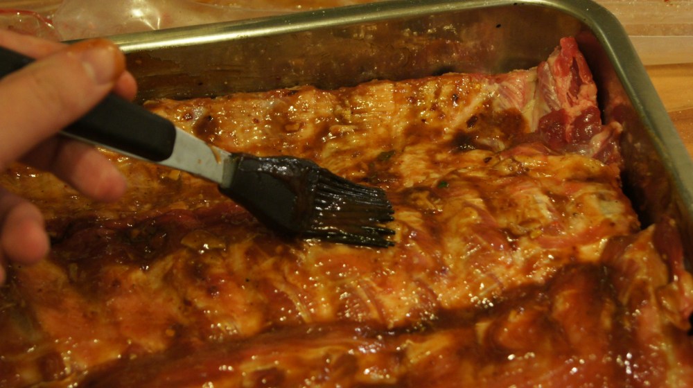 Baste ribs with BBQ sauce